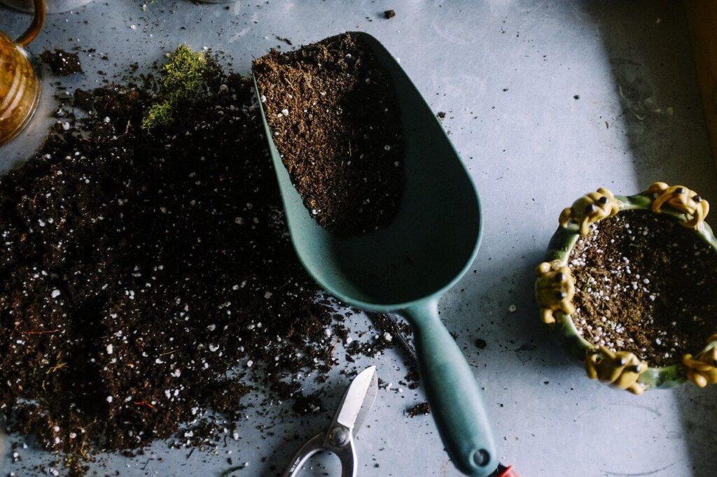 a hand shovel of fertilizer