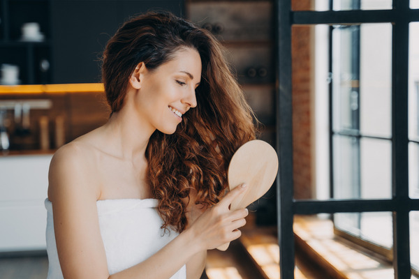 a woman brushing healthy hair
